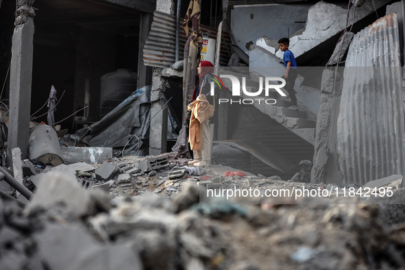 Palestinians inspect the damage after an Israeli strike on the Nuseirat refugee camp in the central Gaza Strip on December 7, 2024, amid the...