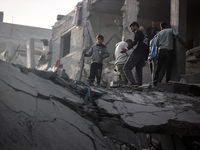 Palestinians inspect the damage after an Israeli strike on the Nuseirat refugee camp in the central Gaza Strip on December 7, 2024, amid the...