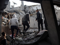 Palestinians inspect the damage after an Israeli strike on the Nuseirat refugee camp in the central Gaza Strip on December 7, 2024, amid the...