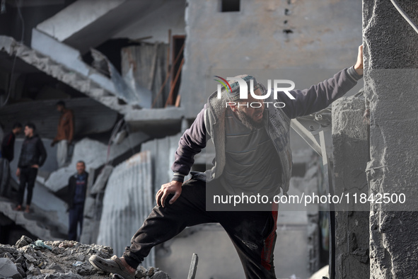 Palestinians inspect the damage after an Israeli strike on the Nuseirat refugee camp in the central Gaza Strip on December 7, 2024, amid the...