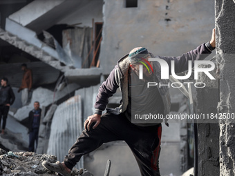 Palestinians inspect the damage after an Israeli strike on the Nuseirat refugee camp in the central Gaza Strip on December 7, 2024, amid the...