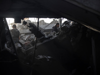 Palestinians inspect the damage after an Israeli strike on the Nuseirat refugee camp in the central Gaza Strip on December 7, 2024, amid the...