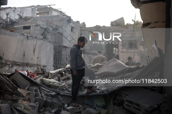 Palestinians inspect the damage after an Israeli strike on the Nuseirat refugee camp in the central Gaza Strip on December 7, 2024, amid the...