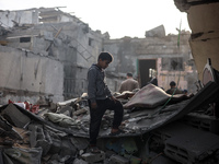 Palestinians inspect the damage after an Israeli strike on the Nuseirat refugee camp in the central Gaza Strip on December 7, 2024, amid the...