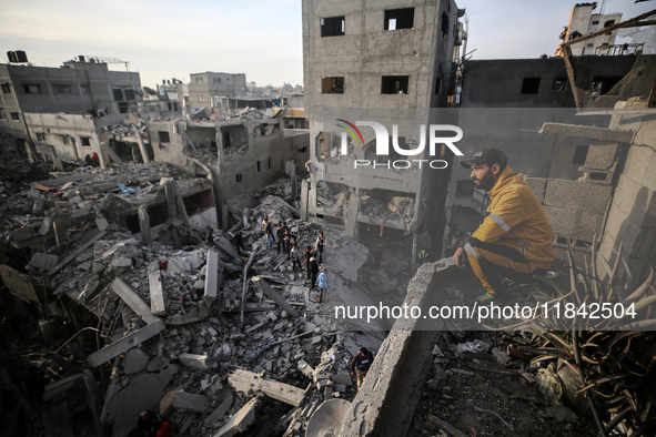 Palestinians inspect the damage after an Israeli strike on the Nuseirat refugee camp in the central Gaza Strip on December 7, 2024, amid the...