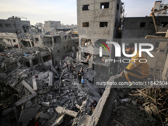 Palestinians inspect the damage after an Israeli strike on the Nuseirat refugee camp in the central Gaza Strip on December 7, 2024, amid the...