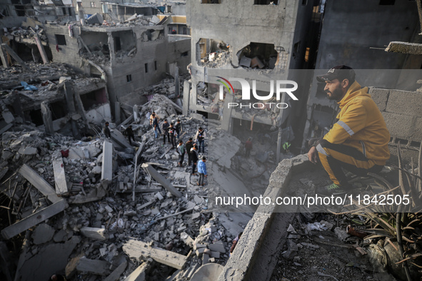 Palestinians inspect the damage after an Israeli strike on the Nuseirat refugee camp in the central Gaza Strip on December 7, 2024, amid the...