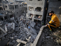 Palestinians inspect the damage after an Israeli strike on the Nuseirat refugee camp in the central Gaza Strip on December 7, 2024, amid the...