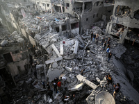 Palestinians inspect the damage after an Israeli strike on the Nuseirat refugee camp in the central Gaza Strip on December 7, 2024, amid the...