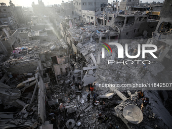 Palestinians inspect the damage after an Israeli strike on the Nuseirat refugee camp in the central Gaza Strip on December 7, 2024, amid the...