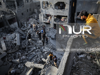 Palestinians inspect the damage after an Israeli strike on the Nuseirat refugee camp in the central Gaza Strip on December 7, 2024, amid the...