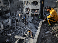 Palestinians inspect the damage after an Israeli strike on the Nuseirat refugee camp in the central Gaza Strip on December 7, 2024, amid the...