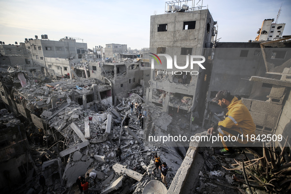 Palestinians inspect the damage after an Israeli strike on the Nuseirat refugee camp in the central Gaza Strip on December 7, 2024, amid the...