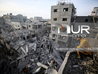 Palestinians inspect the damage after an Israeli strike on the Nuseirat refugee camp in the central Gaza Strip on December 7, 2024, amid the...