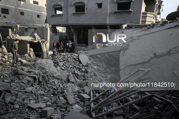 Palestinians inspect the damage after an Israeli strike on the Nuseirat refugee camp in the central Gaza Strip on December 7, 2024, amid the...