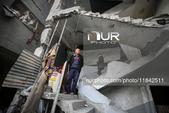 Palestinians inspect the damage after an Israeli strike on the Nuseirat refugee camp in the central Gaza Strip on December 7, 2024, amid the...