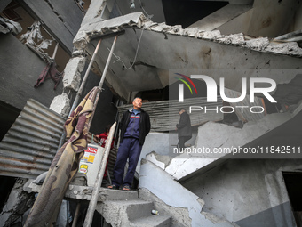 Palestinians inspect the damage after an Israeli strike on the Nuseirat refugee camp in the central Gaza Strip on December 7, 2024, amid the...