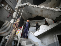 Palestinians inspect the damage after an Israeli strike on the Nuseirat refugee camp in the central Gaza Strip on December 7, 2024, amid the...