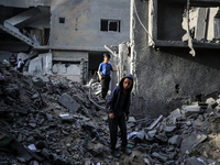 Palestinians inspect the damage after an Israeli strike on the Nuseirat refugee camp in the central Gaza Strip on December 7, 2024, amid the...