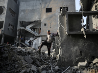 Palestinians inspect the damage after an Israeli strike on the Nuseirat refugee camp in the central Gaza Strip on December 7, 2024, amid the...