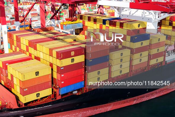 Cargo ships load and unload containers at the foreign trade container terminal in Qingdao Port in Qingdao, China, on December 7, 2024. 