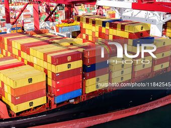 Cargo ships load and unload containers at the foreign trade container terminal in Qingdao Port in Qingdao, China, on December 7, 2024. (