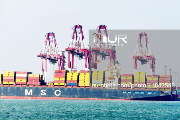 Cargo ships load and unload containers at the foreign trade container terminal in Qingdao Port in Qingdao, China, on December 7, 2024. 