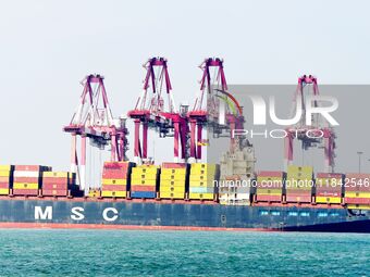 Cargo ships load and unload containers at the foreign trade container terminal in Qingdao Port in Qingdao, China, on December 7, 2024. (