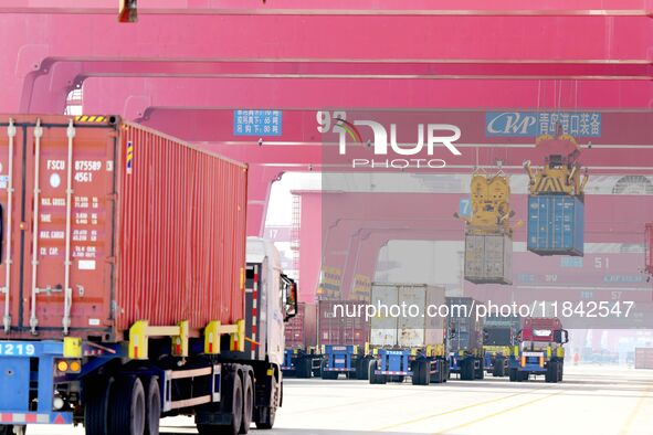 Cargo ships load and unload containers at the foreign trade container terminal in Qingdao Port in Qingdao, China, on December 7, 2024. 