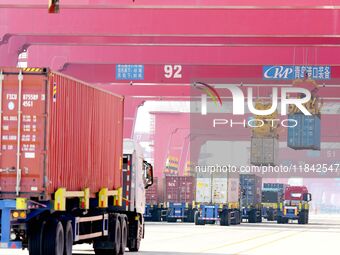 Cargo ships load and unload containers at the foreign trade container terminal in Qingdao Port in Qingdao, China, on December 7, 2024. (