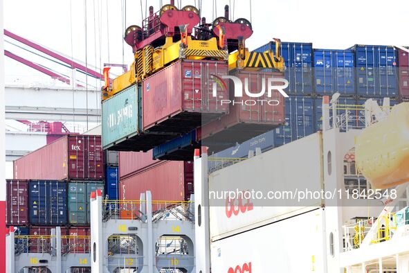 Cargo ships load and unload containers at the foreign trade container terminal in Qingdao Port in Qingdao, China, on December 7, 2024. 