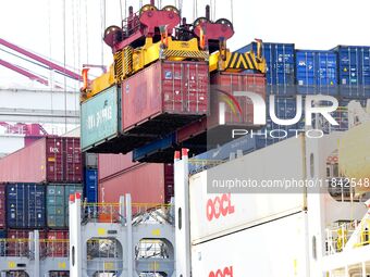 Cargo ships load and unload containers at the foreign trade container terminal in Qingdao Port in Qingdao, China, on December 7, 2024. (