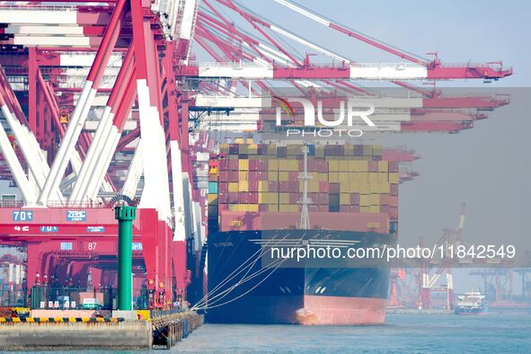 Cargo ships load and unload containers at the foreign trade container terminal in Qingdao Port in Qingdao, China, on December 7, 2024. 