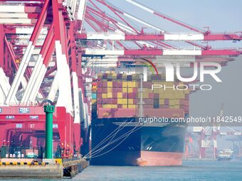 Cargo ships load and unload containers at the foreign trade container terminal in Qingdao Port in Qingdao, China, on December 7, 2024. (