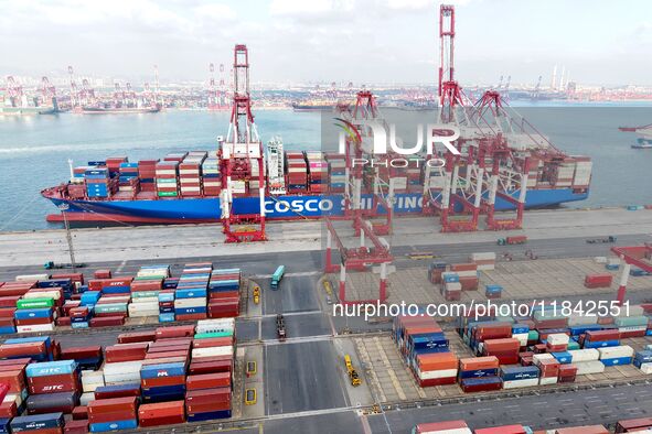 Cargo ships load and unload containers at the foreign trade container terminal in Qingdao Port in Qingdao, China, on December 7, 2024. 