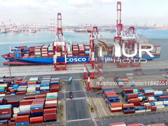 Cargo ships load and unload containers at the foreign trade container terminal in Qingdao Port in Qingdao, China, on December 7, 2024. (