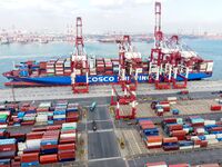 Cargo ships load and unload containers at the foreign trade container terminal in Qingdao Port in Qingdao, China, on December 7, 2024. (