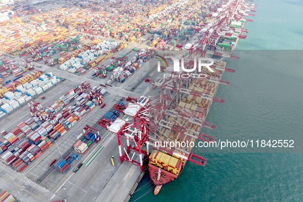 Cargo ships load and unload containers at the foreign trade container terminal in Qingdao Port in Qingdao, China, on December 7, 2024. 