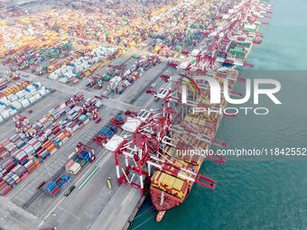 Cargo ships load and unload containers at the foreign trade container terminal in Qingdao Port in Qingdao, China, on December 7, 2024. (