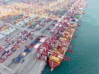 Cargo ships load and unload containers at the foreign trade container terminal in Qingdao Port in Qingdao, China, on December 7, 2024. (