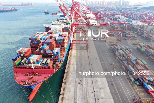 Cargo ships load and unload containers at the foreign trade container terminal in Qingdao Port in Qingdao, China, on December 7, 2024. 