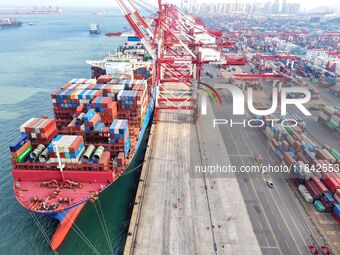 Cargo ships load and unload containers at the foreign trade container terminal in Qingdao Port in Qingdao, China, on December 7, 2024. (