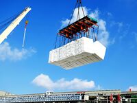 A cargo ship unloads imported pulp at the Xilian terminal of Qingdao Port in Qingdao, China, on December 7, 2024. (