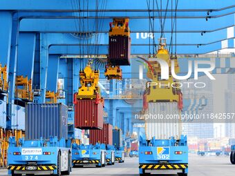 Cargo ships load and unload foreign trade containers at the automated terminal of Qingdao Port in Qingdao, China, on December 7, 2024. (