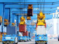 Cargo ships load and unload foreign trade containers at the automated terminal of Qingdao Port in Qingdao, China, on December 7, 2024. (