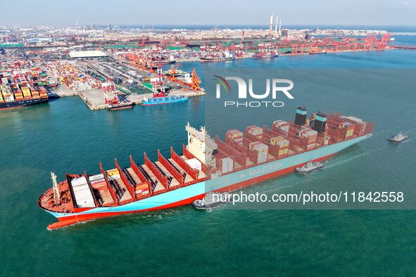 A cargo ship sails towards a foreign trade container terminal at Qianwan Port in Qingdao, China, on December 7, 2024. 