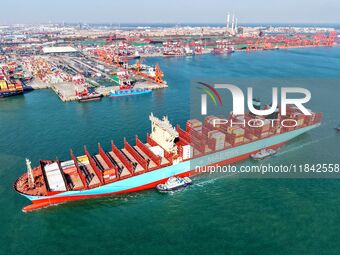 A cargo ship sails towards a foreign trade container terminal at Qianwan Port in Qingdao, China, on December 7, 2024. (