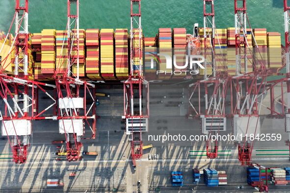 Cargo ships load and unload containers at the foreign trade container terminal in Qingdao Port in Qingdao, China, on December 7, 2024. 