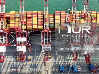 Cargo ships load and unload containers at the foreign trade container terminal in Qingdao Port in Qingdao, China, on December 7, 2024. (