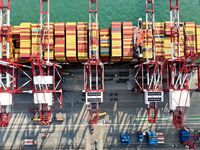 Cargo ships load and unload containers at the foreign trade container terminal in Qingdao Port in Qingdao, China, on December 7, 2024. (